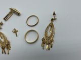two pairs of gold earrings and a pair of gold rings