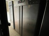 an image of a refrigerator in a dark room with a door open