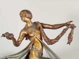 bronze statue of a woman holding a bird in her hand