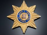an image of a gold and blue star badge on a black background