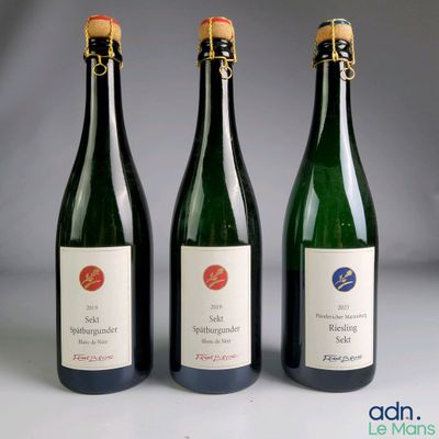 three bottles of wine sitting next to each other on a table
