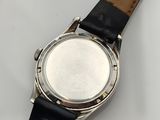 an image of a close up of a watch on a white surface