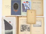 several old books are stacked on top of each other on a table