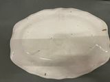 a white plate on a table with a black table cloth