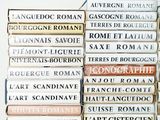 many books stacked on top of each other on a table