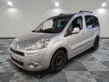 une photo d'une petite camionnette argentée garée dans un garage