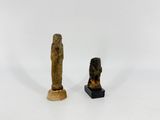 two statues of a man and a woman standing next to each other