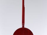 a red acoustic guitar hanging from the back of a white wall