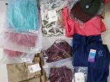a lot of clothes and a hat sitting on a table