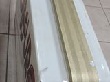 a white and gold sign sitting on a tiled floor