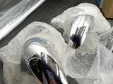 a pair of shiny chrome faucets sitting on a counter