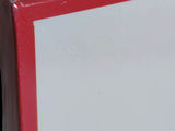 a red and white box with a black cat on it