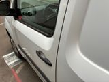 a white van parked in a parking lot with its door open