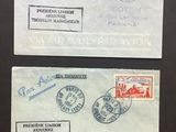 two envelopes with stamps on them sitting on a table