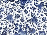 a large blue and white plate with flowers on it