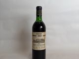 a bottle of wine sitting on top of a white table