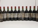 several bottles of wine are lined up in a row on a table