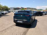 a blue car parked in a parking lot next to other cars