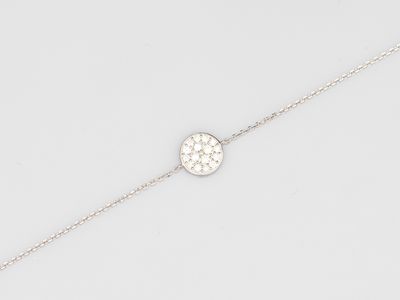 a close up of a silver bracelet on a white background