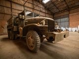 a old military truck parked inside of a building