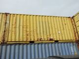 yellow and blue shipping containers stacked on top of each other in a parking lot