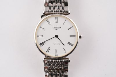 an image of a close up of a wrist watch with roman numerals