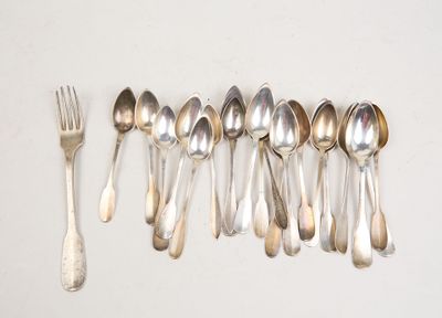 six silver spoons and a fork are lined up on a white surface