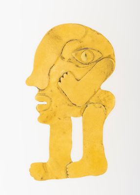 an image of a yellow sculpture of a man ' s face on a white surface