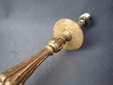 a brass door handle on a gray surface