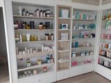 many different types of skin care products on the shelves in this store
