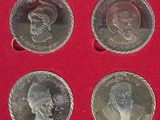four silver coins in a red box on a red surface