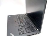 a laptop that is open on a white surface