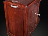 an old wooden cabinet with a metal handle on a black background