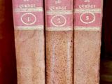 three books that are sitting on a shelf together