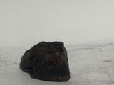 a small piece of rock on the ground in the snow