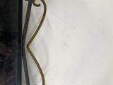 a mirror hanging on the wall with a pair of scissors