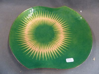 a green plate with a yellow and white design on it