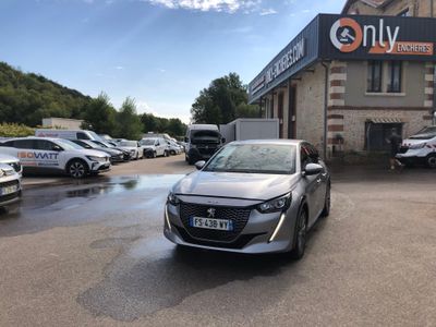 the silver car is parked in front of a building with many cars parked in front of it