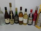 many bottles of wine on the table next to each other