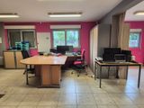 une pièce avec une table, des chaises et un ordinateur portable posé dessus