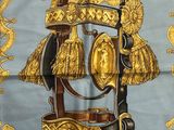 a close up of a horse ' s bridle with a gold and blue background