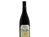 a bottle of wine sitting on top of a white table