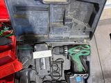 une boîte à outils contenant des outils, posée sur le sol