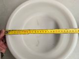 someone is measuring the height of a bowl with a tape