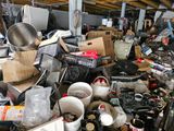 a pile of junk in a garage with a lot of items