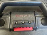 a close up of a black suitcase with a red handle