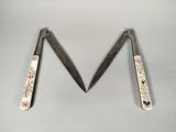 two pairs of scissors sitting next to each other on top of a table