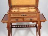 a small wooden table with a drawer on it