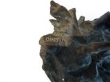 a statue of a man riding a horse on a rock
