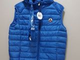 a close up of a blue vest hanging on a wall